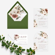 wedding stationery with flowers and greenery on the front, white envelope and green envelope