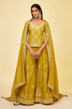 Shop for these amazing collections of Green Chanderi Silk Embroidered Gota And Thread Work V Neck Sharara Set For Women by Shyam Narayan Prasad online at Aza Fashions. Green Dola Silk Sets For Navratri, Green Dola Silk Sharara For Navratri, Designer Raw Silk Palazzo Set For Transitional Season, Green Dola Silk Sets For Diwali, Gold Floor-length Sharara For Transitional Season, Floor-length Green Art Silk Sets, Green Floor-length Art Silk Set, Designer Raw Silk Sharara With Gota Work, Transitional Raw Silk Sharara With Zari Work