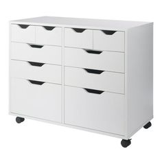 a white dresser with black drawers on wheels