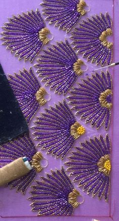 a piece of art that has been made to look like purple flowers and gold leaves