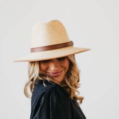 For classic summer style, put on the Buckle Up Brim Sun Hat! This paper hat is outfitted with a fashionable vegan leather belt around the base and a soft faux leather trim around the brim. The inside of the hat has adjustable ties to ensure your perfect fit! * Spot clean * 24" Circumference * 3" Brim * Material: 100% Paper Chic Visor Sun Hat For Travel, Brown Brimmed Fedora With Upf 50+, Chic Everyday Brimmed Panama Hat, Everyday Chic Brimmed Panama Hat, Summer Visor Panama Hat For Travel, Summer Panama Visor Hat For Travel, Chic Brimmed Boater Hat For Travel, Summer Travel Panama Hat With Visor, Spring Wide Brim Fedora For Everyday