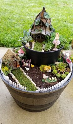 a potted planter filled with miniature fairy houses