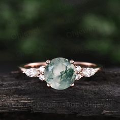 "This is a moss agate engagement ring in solid gold,about 7mm round cut. The accent stones are round 1.5mm and marqueise 2x4mm moissanites. It can be made in any ring size. However please contact me to custom make it to a special big or small size. It can be made in white gold,rose gold or yellow gold with 14k or 18k. However for some people who are nickel allergic,I can also make it to 925 sterling silver to make you can wear it. The ring is handmade,very high quality! 30 days money back guaran Timeless Jewelry With Gemstone And Round Band, Timeless Gemstone Jewelry With Round Band, Delicate Rose Gold Moissanite Jewelry, Delicate Gemstone Ring Jewelry, Dainty Diamond Jewelry For May Birthstone, Dainty Cubic Zirconia Round Band Jewelry, Timeless Round Cut Gemstone Jewelry, Fine Jewelry Round Promise Ring, Dainty Emerald Cut Jewelry With Bezel Setting