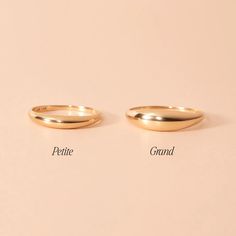 two gold wedding rings with the words petite and grand written on them