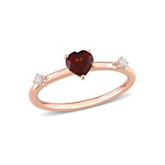 This pretty 3-stone stackable heart ring is crafted in 10-karat rose gold and features a heart-cut, prong-set garnet gemstone studded at the center with two round-cut, prong-set white topaz gemstone augmented on its band in station style. Enhanced with a high polished finish, this stackable ring is the perfect addition to any jewelry collection. Pair this trendsetting ring with any business or casual outfit and look elegant. 5/8 Carat (ctw) Garnet Heart Promise Ring in 10K Rose Pink Gold with Wh Heart Promise Rings, Garnet Heart, Rose Gold Plated Ring, Rose Gold Morganite, 14k Rose Gold Ring, Gemstone Studs, 14k White Gold Ring, Stone Heart, Garnet Gemstone