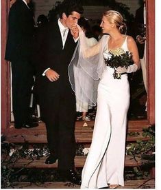 a bride and groom are standing in front of an open door at their wedding ceremony