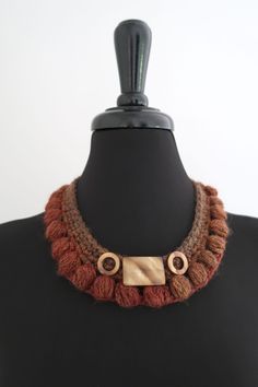 This beautiful collar necklace will be the unique accent to your outfit. I used soft and lightweight acrylic/wool mix yarn that gradually changes color from amber brown to dark sienna. It is embellished with crochet flower and shell beads. The necklace gently stretches to fit over everyone's head. More necklaces : http://www.etsy.com/shop/KnitsomeStudio?section_id=7896440 Don't forget to check out my other items! There are many more in my shop -- http://knitsomestudio.etsy.com Copyright © 2021, Brown Bohemian Crochet Jewelry, Bohemian Brown Crochet Jewelry, Sienna Color, Amber Brown, Collar Choker, Choker Collar, Crochet Flower, Shell Beads, Collar Necklace