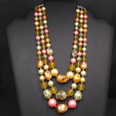 *Description: This is a beautiful Japan necklace which has a variety of multicolored round glass beads with accent art beads which have been hand painted so no two are alike. The necklace also has small bugle beads as spacers, from the 1950s. Japan necklaces have very unique and artistic bead accents. Each one is a beautiful piece of art and no two are alike. This would be a great addition to your vintage jewelry collection or make a great vintage gift! *Approximate Measurements: Length - 17 Inc Vintage Jewelry With Large Round Beads, Large Vintage Beads For Jewelry Making, Vintage Jewelry With Wooden Round Beads, Vintage Beaded Necklaces With Colorful Beads, Vintage Style Wooden Beads For Jewelry Making, Vintage Multi-strand Colorful Beaded Necklaces, Vintage Multi-strand Beaded Necklaces With Colorful Beads, Vintage Multi-strand Beaded Necklace With Colorful Beads, Vintage Necklaces With Wooden Beads