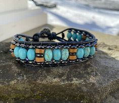 Handmade Turquoise Leather Bracelet Spiritual, Handmade Turquoise Wrap Bracelet, Bohemian Turquoise Beaded Bracelets With Black Beads, Bohemian Turquoise Beaded Bracelet With Black Beads, Rustic Adjustable Turquoise Beaded Bracelets, Adjustable Blue Artisan Leather Bracelet, Bohemian Leather Beaded Bracelet For Healing, Turquoise And Black Beaded Bohemian Bracelet, Casual Turquoise Beaded Bracelets Hand Wrapped