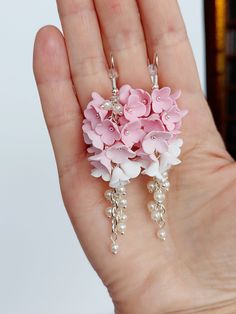 https://purplebeestudio.etsy.com Handmade chandelier earrings in shades of pink. The flowers are handmade from polymer clay by me without using any molds. These very elegant delicate earrings will become your favorits for many occasions. Earrings made with stainless steel ear wire. The earrings are very light and comfortable to wear all day. SHIPPING: Your order will be dispatched in a securely packed cardboard box. Product care:  - To ensure the product quality and durablility, avoid contact with water, lotion, perfumes and household cleaners and chemicals. - You can clean the products with a slightly damp soft fabric.  - Sharp objects can damage the clay surface. - When not in use, store in a dry, seperate box. Thank you for visiting my shop! If you have any special requests, I'll be hap Flower Earrings Wedding, Clay Flower Earrings, Bridal Party Earrings, Handmade Chandelier, Handmade Clay Jewelry, Clay Flower, Floral Jewelry, Jewelry Bridesmaid, Pink Bridal