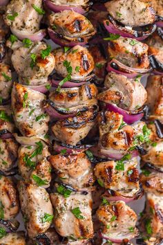 grilled chicken and onions on skewers with herbs