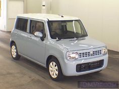 a small blue car parked in a garage