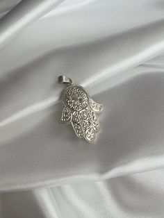 ♥ Click the link below to see more beautiful modern Hamsa Hands and Earrings: https://www.etsy.com/shop/FUENTESCOLLECTIONSNL Each Hamsa Hand pendant is handcrafted with precision and care, ensuring that no two pieces are exactly alike. The handmade nature of this pendant adds a unique touch and a sense of authenticity that mass-produced jewelry simply cannot replicate. Crafted from high-quality silver, this pendant features a beautifully detailed Hamsa Hand design that symbolizes protection, goo Unique Pendant Charms As Gifts, Spiritual White Gold Pendant Jewelry, Sterling Silver Oval Pendant, Sterling Silver Oval Pendant With Clasp, Sterling Silver Jewelry With Oval Pendant, Symbolic Silver Dangle Jewelry, Spiritual Sterling Silver Charms, Traditional Sterling Silver Teardrop Pendant Necklace, Elegant Sterling Silver Charms For Gifts