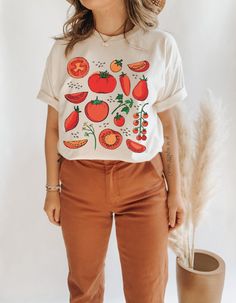 Tomato Shirt Fruit Shirt Grow, Harvest, Eat - Repeat! Celebrate the joys of gardening with this vibrant tee, designed for the tomato enthusiast who loves the cycle of growing, harvesting, and savoring the fruits of their labor. It's a perfect pick for any tomato-loving gardener. Be sure to check the size chart within the listing. Some of the models are wearing oversized apparel. Size up from your usual size to achieve this look! Please reach out if your desired color, size or garment style is no Fruit Outfits, Tomato Shirt, Gardening Clothes, Etsy Clothes, Fruit Shirt, Shirt Inspiration, Cottagecore Shirt, Botanical Shirt, Vegan Shirt