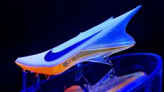 the nike shoe is lit up in blue and orange