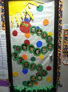 a classroom door decorated with paper circles and pictures of children's faces on it