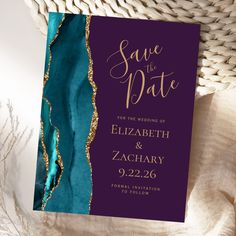 save the date card with gold foil and teal blue marbled paper on top