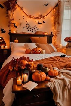 a bedroom decorated for halloween with pumpkins and candles