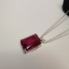 "Gorgeous Ruby Pendant Necklace * 8ct Emerald Cut Ruby measures 14mm x 10mm * Solid Sterling Silver * 18\" Sterling Silver Chain Included This Gorgeous 8ct Ruby is a laboratory grown stone. It is identical to the genuine stone in every way, including chemistry, composition and hardness, with an outstanding cut, clarity and color refraction. Hallmarked & Gift Ready! Matching Earrings and/or Ring also Available! TIMELESS, BEAUTIFUL & UNIQUE FINE ART JEWELRY" Formal Octagon Ruby Jewelry, Sterling Silver Jewelry With Rectangular Prong Setting, Classic Ruby Necklace With Prong Setting, Silver Ruby Necklace With Prong Setting, Sterling Silver Jewelry With Rectangular Stone And Prong Setting, Sterling Silver Jewelry With Rectangular Stone In Prong Setting, Formal Ruby Jewelry With Faceted Details, Classic Octagon Necklace For Anniversary, Classic Ruby Gemstone Necklace