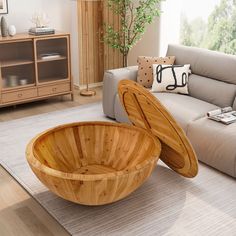 a large wooden bowl sitting on top of a rug in a living room next to a couch