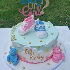 a baby shower cake with teddy bears and shoes on the top, which says do you eat?