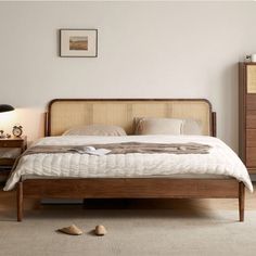 a bed sitting on top of a wooden frame in a bedroom