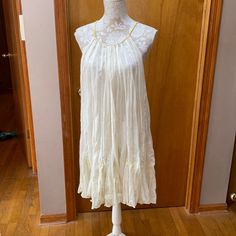 Done In A Super Sheer Cotton, This Nwot Free People Dress Would Make An Awesome Swimsuit Coverup For Your Spring Break! Pale Yellow (Almost A Cream) With Embellished Bright Yellow Tie Back Adjustable Rope Neck. Free Flowing Gussets At Hem. Deep Armholes. Appx 35” Shoulder To Hem. Size Xs Yellow Tie, Yellow Ties, Free Flowing, People Dress, Pale Yellow, Free People Dress, Bright Yellow, Tie Backs, Tie Back