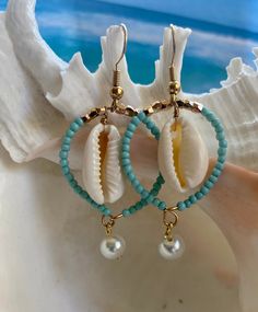 Aqua/light blue seed beads with gold accent beads fill the wire 1 inch hoop with a small cowry to dangle inside the hoop and a small glass pearl (or aqua sea glass chip) dangles below the hoop. Total length is 1-3/4 inch with fish hook Shell Hoop Earrings, Cowry Shell, Earrings Dangling, Matching Earrings, Gold Accents, Aqua Blue, Seed Beads, Etsy Gifts, Dangle Drop Earrings