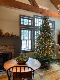 a living room with a christmas tree in the corner and other decorations on the table