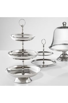 three tiered serving trays with a clochet on each one and a bell on the other