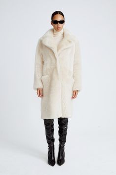 Winter White Sheepskin Outerwear With Faux Fur Trim, Winter White Sheepskin Outerwear With Faux Fur Lining, Winter White Sheepskin Fur Coat For Fall, Winter White Sheepskin Outerwear For Winter, Winter White Sheepskin Outerwear, Winter White Long Fur Coat With Faux Fur Trim, Luxury Faux Fur Coat For Cold Weather, Chic White Sheepskin Outerwear, Winter White Faux Fur Coat