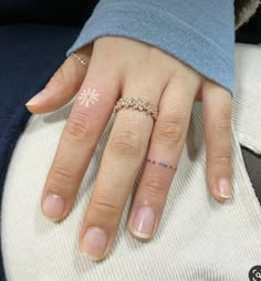 a woman's hand with two different rings on her left and the other half of her finger