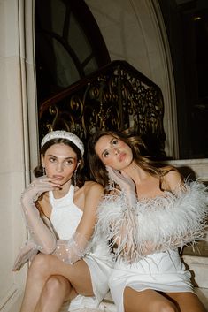 two beautiful young women sitting next to each other