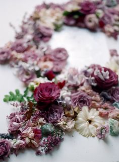 a bunch of flowers that are laying on a table together in the shape of a wreath