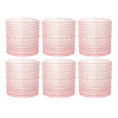 six pink glass candlesticks on a white background