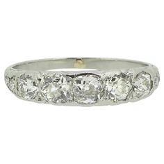 Here we have a splendid five-stone diamond ring taken from the late Victorian era. This antique piece has been crafted from platinum and features five round faceted old cut diamonds in a single line formation across the face. A duo of matching slightly smaller stones can be found at either shoulder before the ring is made complete by an ornate under-gallery and lightly engraved shank. Condition: Used (Very Good) Weight: 3.2 grams Ring Size: K 1/2 (51) Total Diamond Weight: Approx. 1.00ct Diamond Single Line, La Face, Ring Box, Victorian Era, Fashion Rings, The Face, Diamond Cuts, Diamond Ring, Platinum