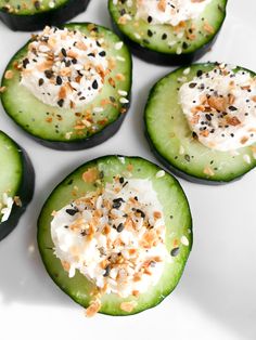 cucumbers topped with whipped cream and sprinkles on a white plate