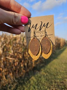 Show off your team spirit with these fun sparkle and embossed football earrings! So cute and lightweight, and can be worn with so many different outfits! Made with genuine leather. The full length of this earring is 2.9" long with a drop length of 2.1", the width measures 1.2" wide. *The pattern of the leather may vary slightly from the photo due to the uniqueness of the leather. Leather pattern is only on the front side of the earrings. School Spirit Earrings, 2024 Jewelry, Diy Leather Earrings, Football Earrings, Leather Jewellery, Leather Diy Crafts, Football Football, Leather Crafts, Carthage