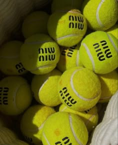 a bag full of tennis balls with the words win written on them