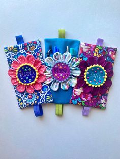 three colorful notebooks decorated with flowers and personalized writing on the front one has a name