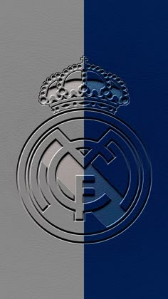 the real madrid logo is shown in silver and blue colors, with a crown on top