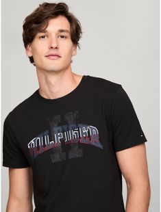 Tommy Hilfiger men's T-shirt. Made from lightweight cotton jersey, known for its breathability and stretch, our comfortable crewneck tee is cut in an easy fit and finished with our Hilfiger graphic.  Material: 100% Cotton. Tommy Hilfiger Graphic Print T-shirt For Streetwear, Tommy Hilfiger Sporty T-shirt With Graphic Print, Tommy Hilfiger Sporty Graphic Print T-shirt, Tommy Hilfiger Sporty Black Tops, Tommy Hilfiger Graphic Tee For Streetwear, Tommy Hilfiger Graphic Tee For Summer, Tommy Hilfiger Summer Graphic Tee, Tommy Hilfiger Graphic Print Crew Neck T-shirt, Tommy Hilfiger Crew Neck T-shirt With Graphic Print