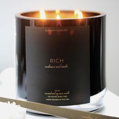 a candle that is sitting on a table next to a knife and some paper with the words rich written on it