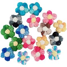 multicolored crochet flowers are arranged in a circle on a white background