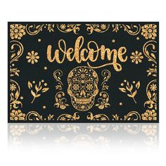 a black and gold welcome mat with a golden sugar skull on the front that says,'welcome '