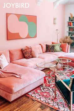 a living room filled with furniture and pink walls