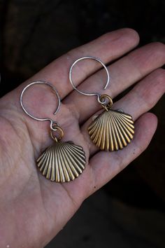 "To find a perfectly in tact shell on the beach is such a treat and visual pleasure. Two perfect solid raw brass shells hang from a hand hammered solid brass ring with hand hammered solid sterling 16g wire wide ear hooks. I would call these a light weight earring. I offer two types of ear hooks for these earrings, this listing is for stretched ear wire hooks for stretched ears. I also offer these earrings with standard earring hooks for regular pierced ears in a separate listing in my shop. See Nickel-free Ocean-inspired Shell-shaped Shell, Ocean-inspired Nickel-free Shell-shaped Shell, Nickel-free Ocean-inspired Shell, Beach Jewelry For Pierced Ears, Shell-shaped, Beach Brass Drop Earrings, Shell-shaped Jewelry With Matching Earrings For The Beach, Shell-shaped Brass Jewelry For The Beach, Metal Beach Jewelry With Matching Earrings, Adjustable Shell Earrings With Ocean-inspired Style