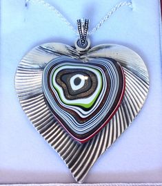 "Fordite Detroit Agate Heart necklace on Silver Heart Italian Silver Chain  Pendant is 2.25\" long including the bail  Comes in a leatherette gift box" Multicolor Heart Pendant Jewelry For Gift, Multicolor Double Heart Jewelry Gift, Multicolor Double Heart Jewelry For Gift, Elegant Multicolor Heart Necklace Gift, Elegant Multicolor Heart Necklace For Gift, Brown Heart Shaped Jewelry With Heart Beads, Brown Heart Charm Jewelry Gift, Clay Arts, Silver Chain Pendant