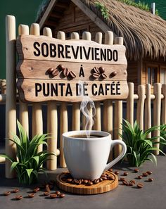 a cup of coffee sitting on top of a table next to a sign that says sobbrevimentoo a la punta de cafe