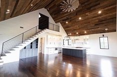 an empty room with wood floors and white walls